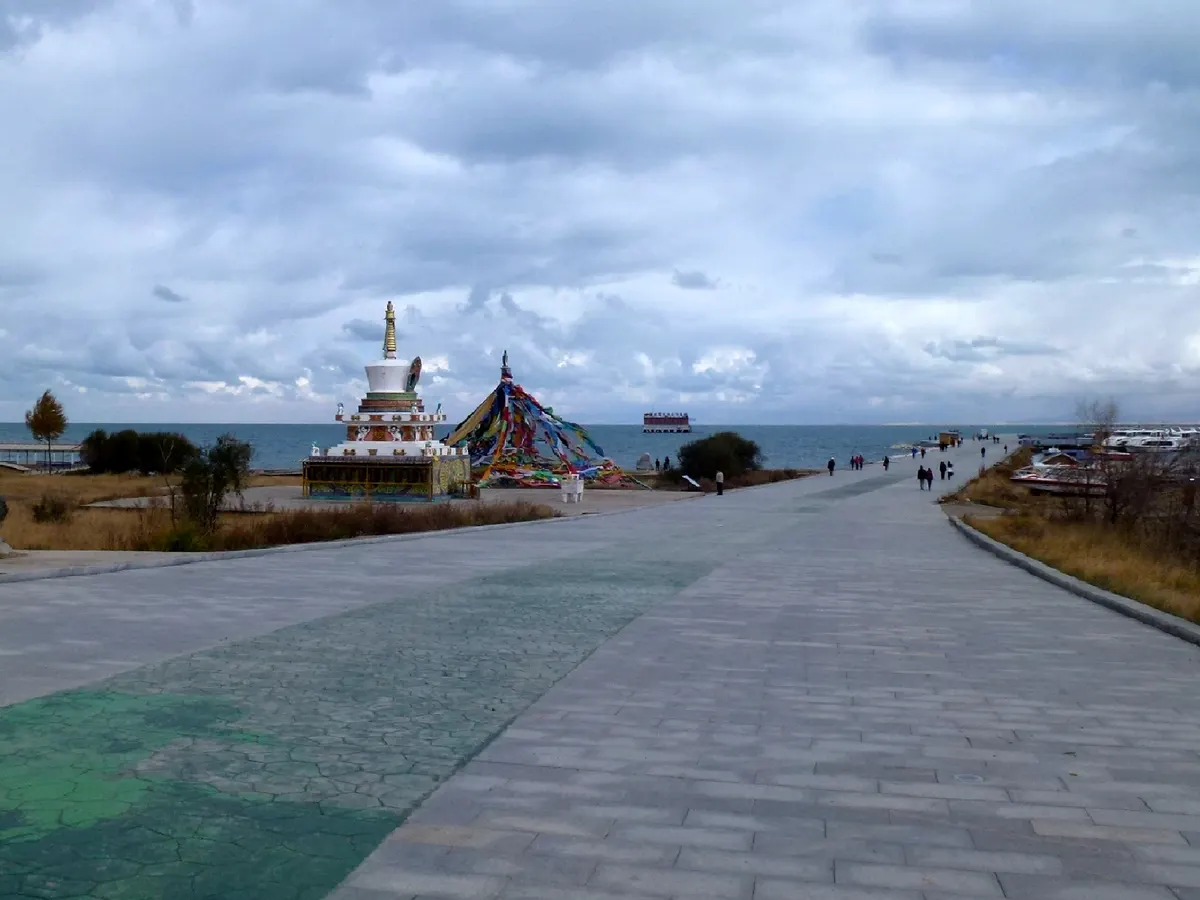 Qinghai Lake with clear blue water and distant mountains in July